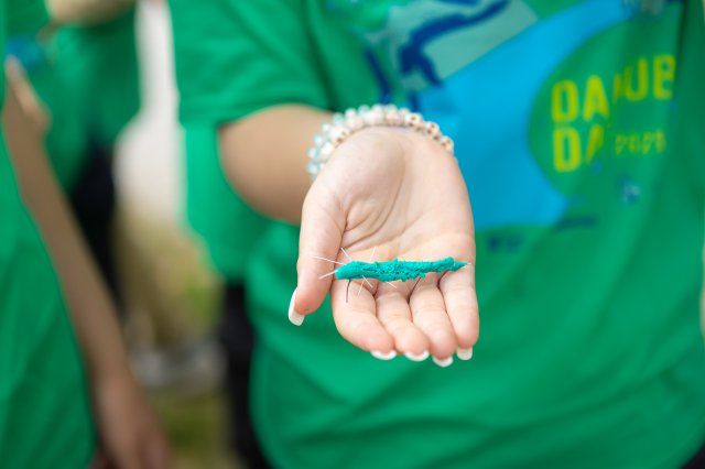Hand holding a homemade craft. 