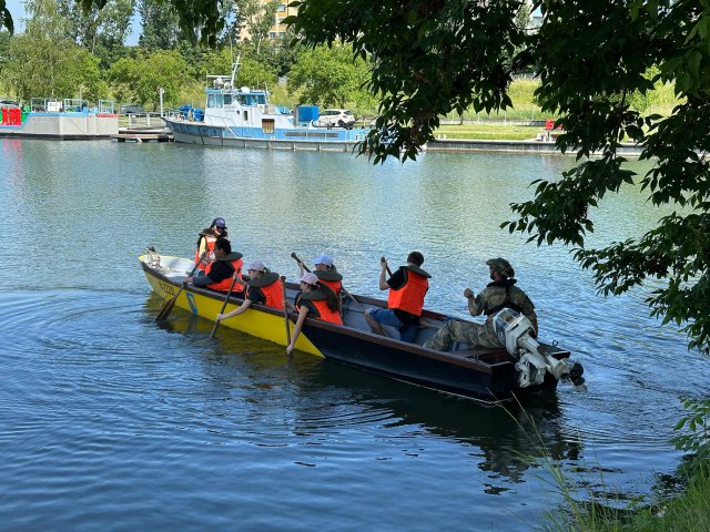 Seven people sitting in a motorboat on the Danube. 