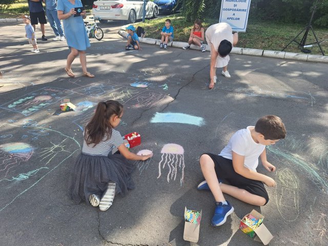 Children drawing with chalk on concrete.