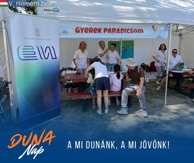 Children stand under a tent set up for Danube Day 2025.