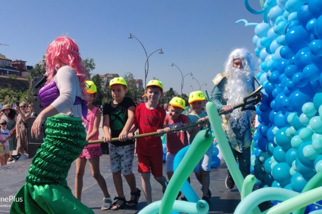 Woman in mermaid costume participating in Danube Day event with children