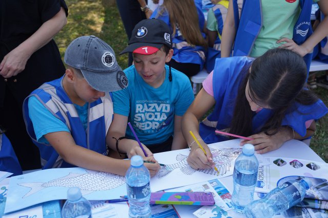 Children drawing on a colouring book 